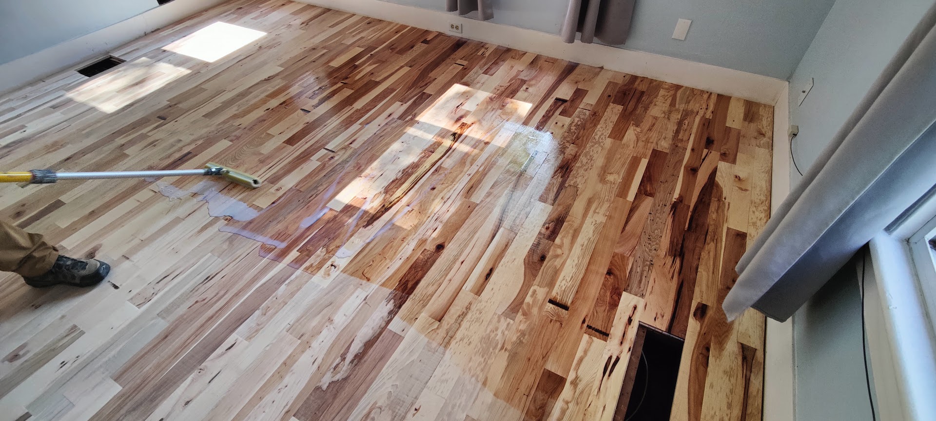 Hardwood floor staining and finishing work in residential home