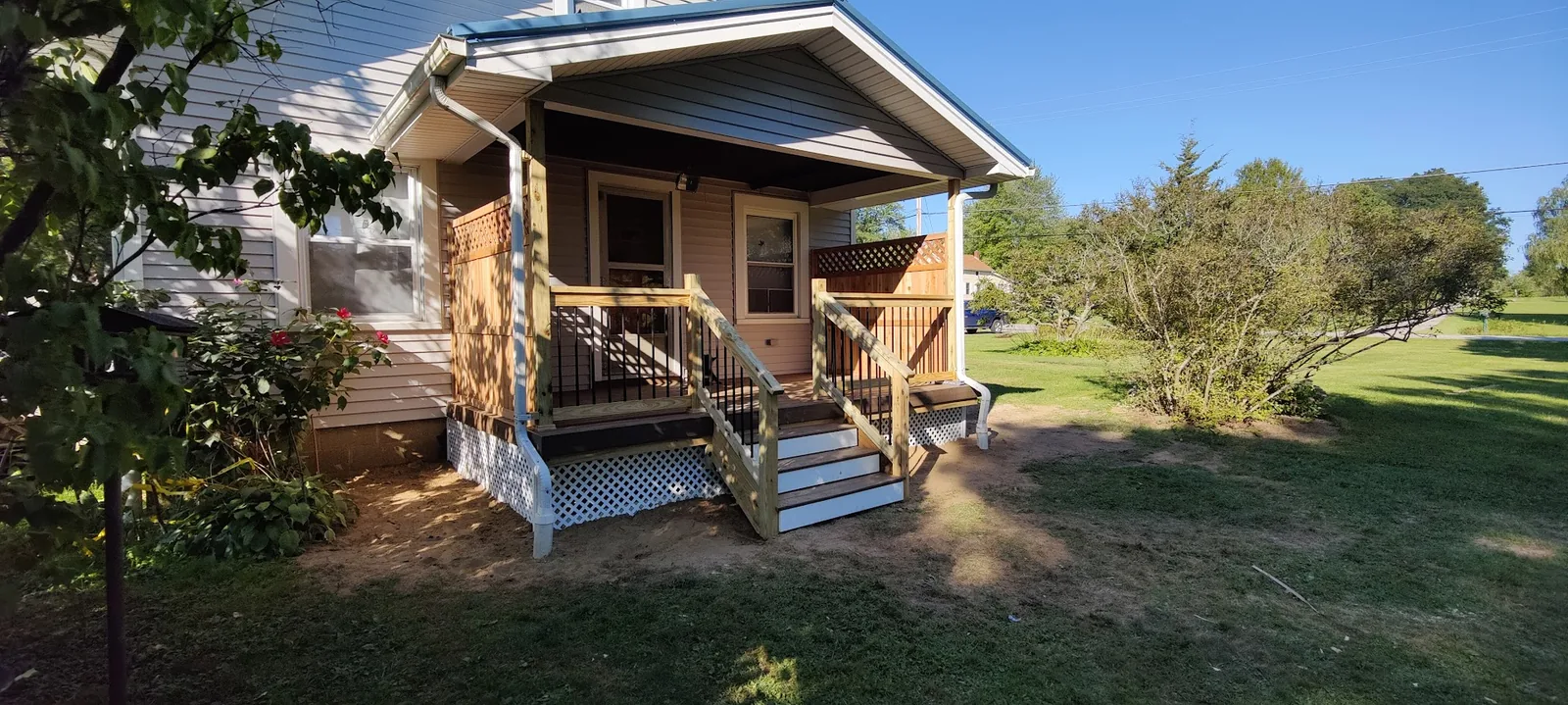Custom Front Porch Build - A beautiful covered front porch with custom railings, lattice detailing, and enhanced curb appeal for this Ohio home.